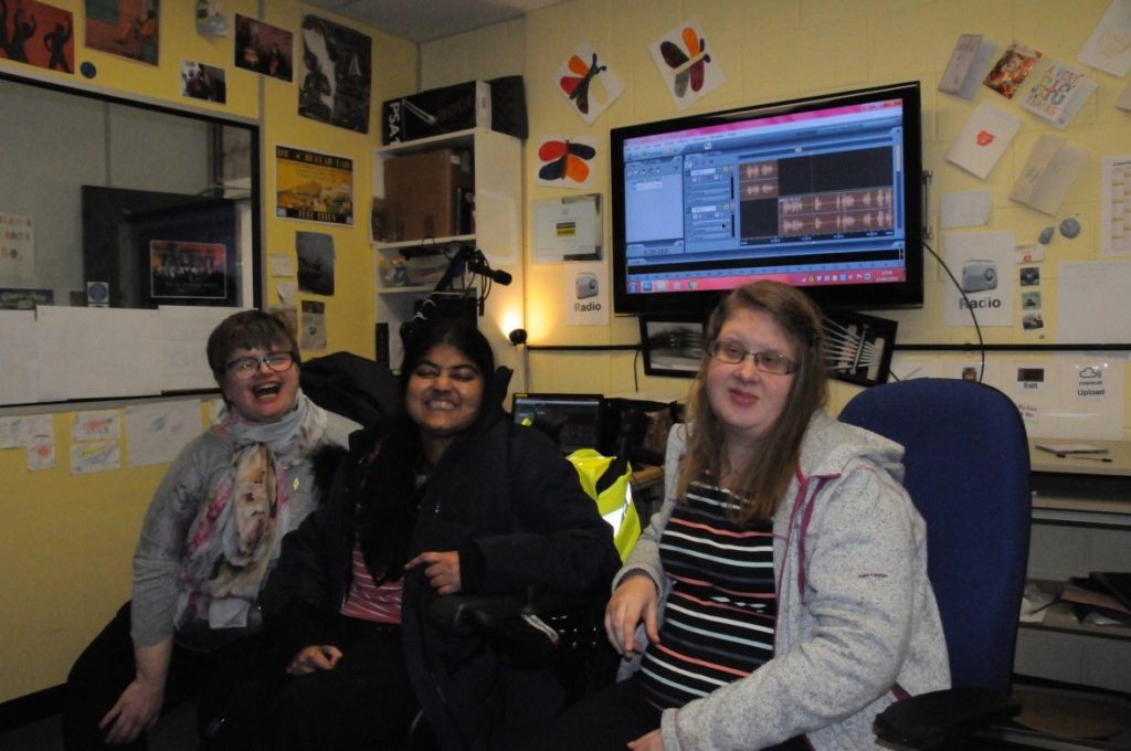 Debbie, Rahima & Louise sitting with the computer used to edit in the background