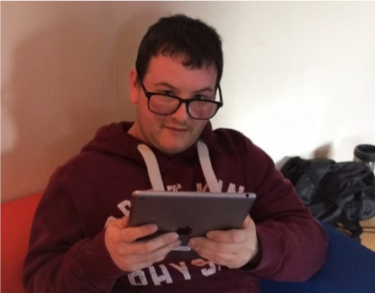 Tim, sitting and using an iPad