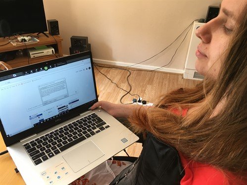 Dorota, using assistive technology to write a letter on her laptop
