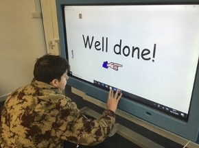 Charlie completing the task and is being given praise in the form of “Well done!” text displayed on the screen