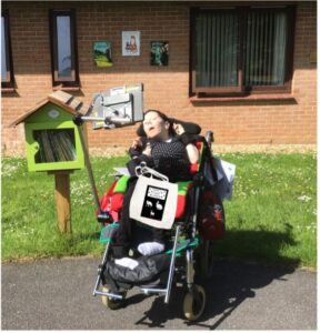 A student in a wheelchair who works at Treloar Enterprise Printing Solutions 