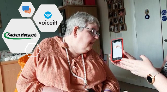 Nuvoic participant speaking into the Voiceitt app on an iPhone being held by a support worker 