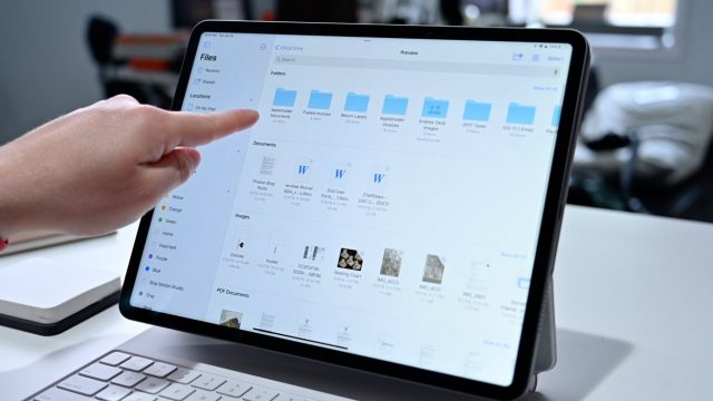 Photo showing a person's hand point to the Files app open on an iPad