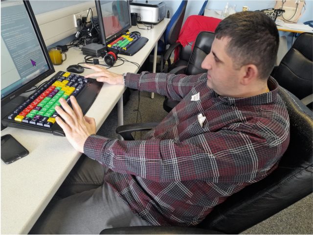 Kadr, sitting in front of a computer working