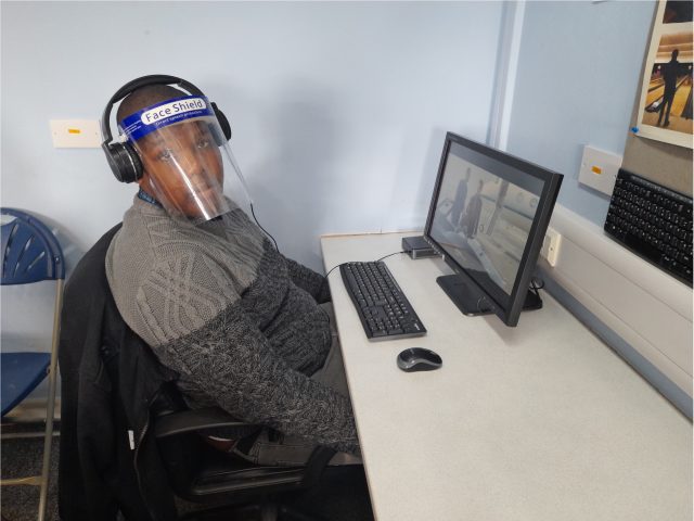 A student sat in front of a computer working