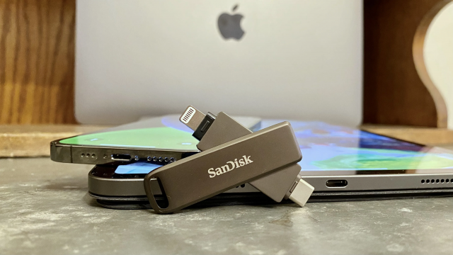 An iPhone, iPad and SanDisk Ixpand Drive on a table