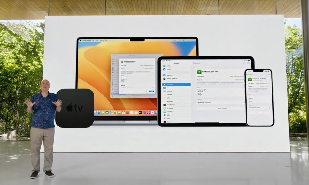 Man presenting Apple's new PassKeys with Apple devices being shown on a screen behind him