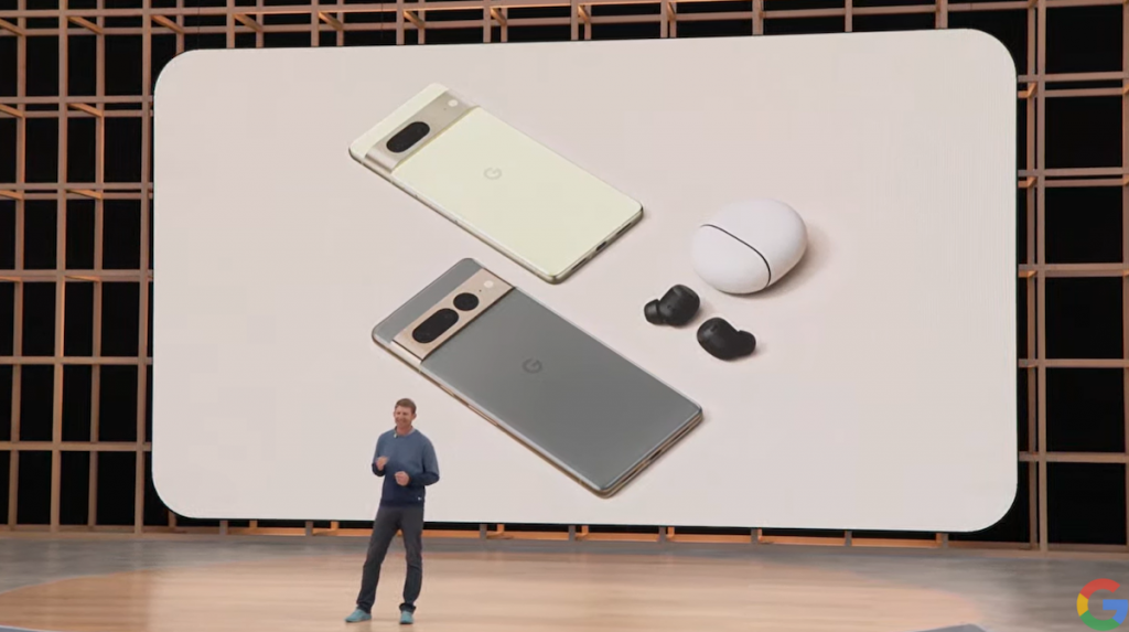 Man stading on the GoogleI/O stage talking about the New Pixel phone which are shown an screen behind him