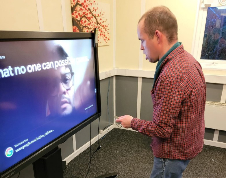 Ben interacting with the giant touch screen 