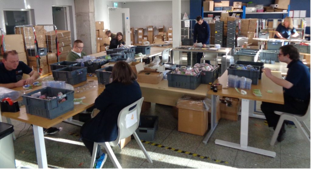 People sitting at electric height adjustable desks creating seasonal personalised gifts and treats 