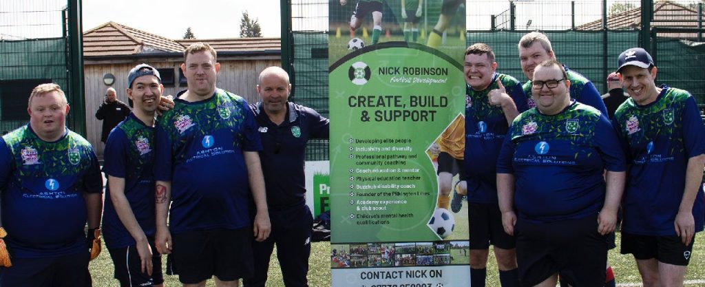 Buzz Hub football team standing together in front of a banner that reads "Nick Robinson, create, build & Support"