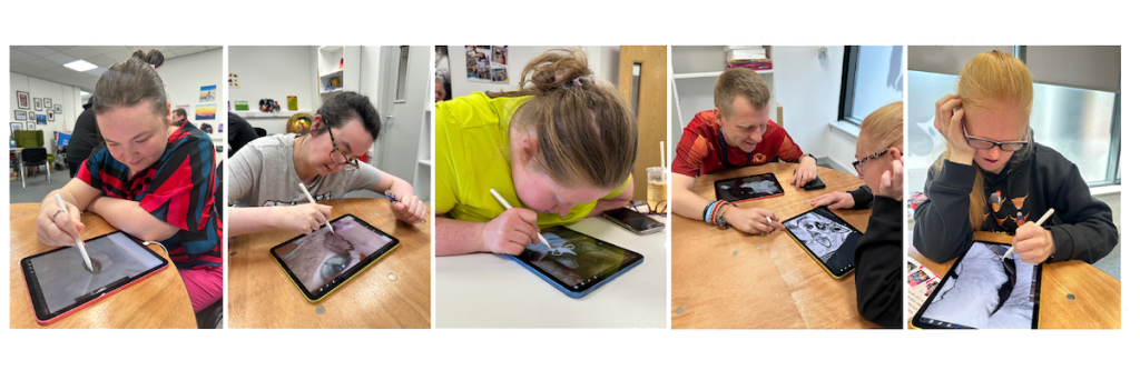 Buzz Hub members using tablets and digital pens to illustrate animals for a creative project in support of Max’s Legacy animal rescue, focusing on digital drawing and concentration.